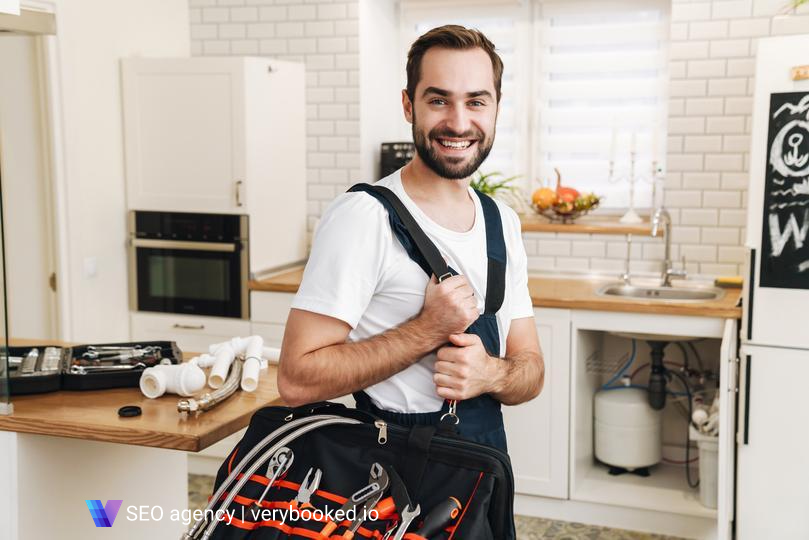 seo-agency for home service contractors  - image-of-plumber-man-smiling-and-holding-bag